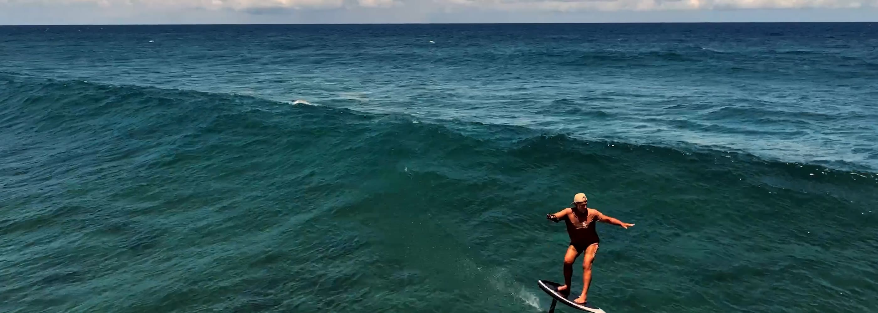 Rider flying over open ocean on a Lift eFoil hydrofoil board